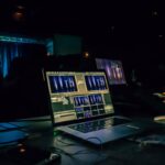 black laptop computer turned on on table